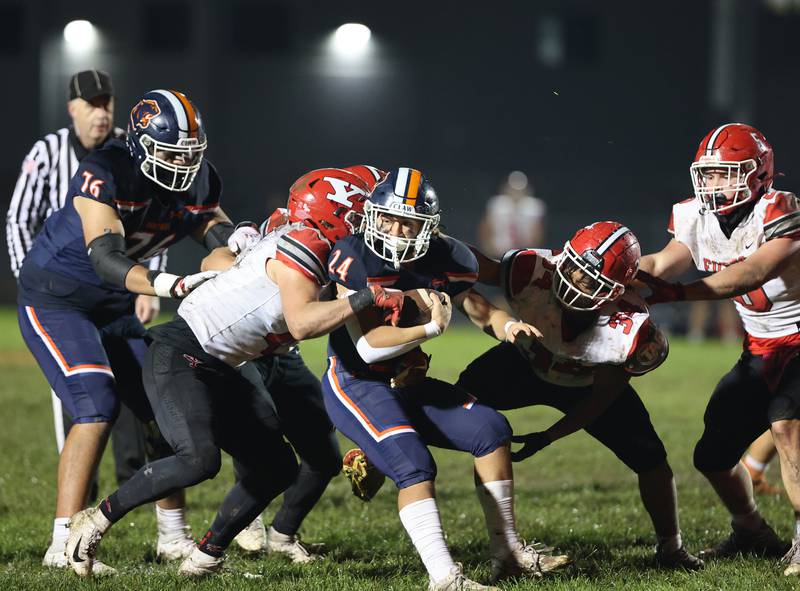 Oswego’s Ayden Villa (24) is wrapped up by Yorkville’s defense during the boys varsity football game on Friday, Oct. 6, 2023 in Oswego.
