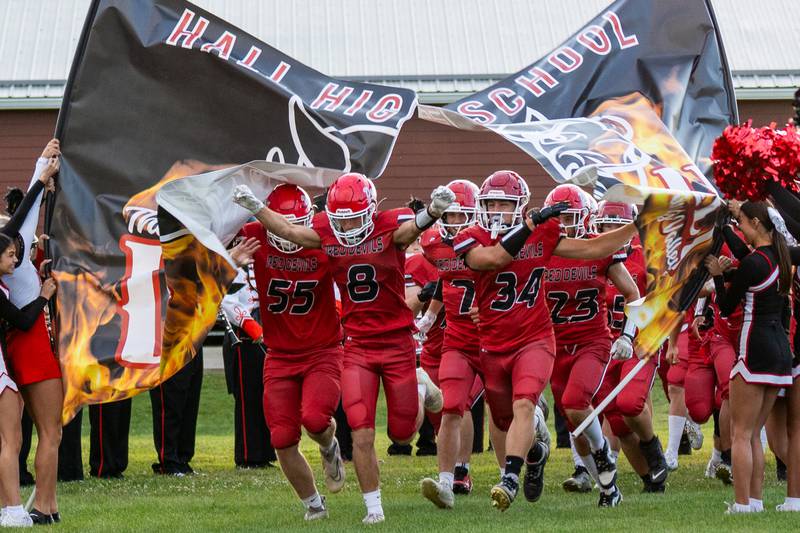Hall football players storm through banner to start off their home opening game against Erie-Prophetstown on Friday, Sept 5, 2025 at Richard Nesti Stadium in Spring Valley.