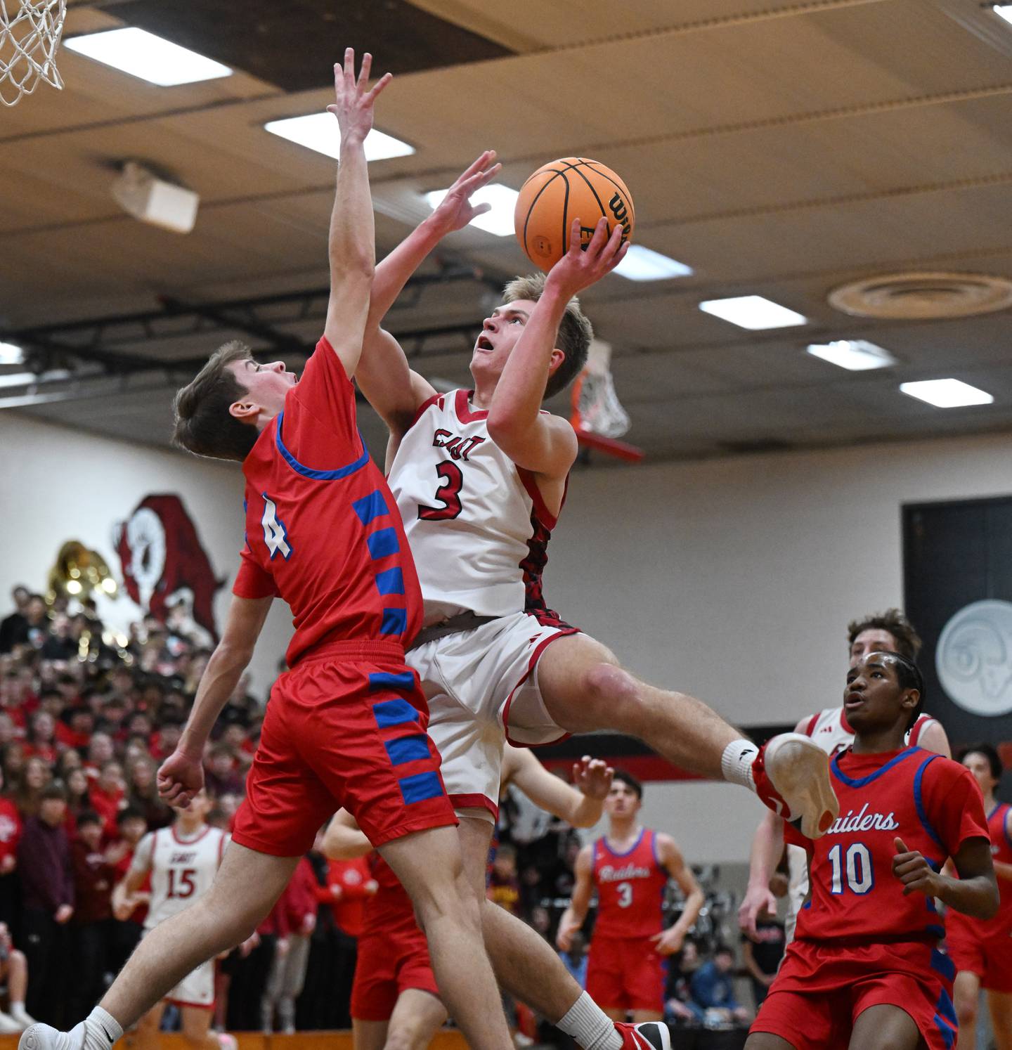 Glenbard East's Danny Snyder, right, makes a move to the basket against Glenbard South's PJ Lehr during Friday’s game in Lombard.