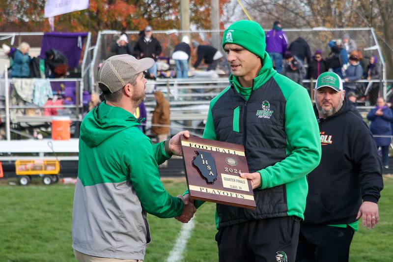 Jacob Scheuer (left) hands coach of Dwight/Gardner-South Wilmington plaque on Saturday, November 16, 2024 at Dwight High School in Dwight.