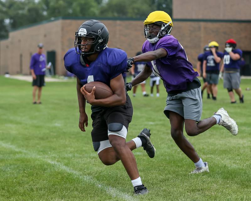 Andrew Cox runs with the ball at Plano High School football practice.  August 9, 2023.