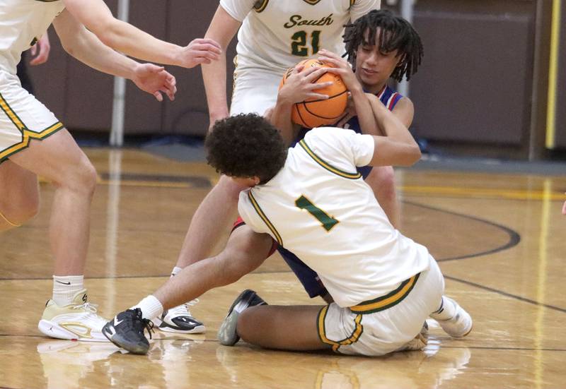 Crystal Lake South’s Noah Cook, front, tussles with Lakes’ Dorian Pullen  in varsity boys basketball Hinkle Holiday Classic action on Friday, Dec. 26, 2025, at Jacobs High School in Algonquin.