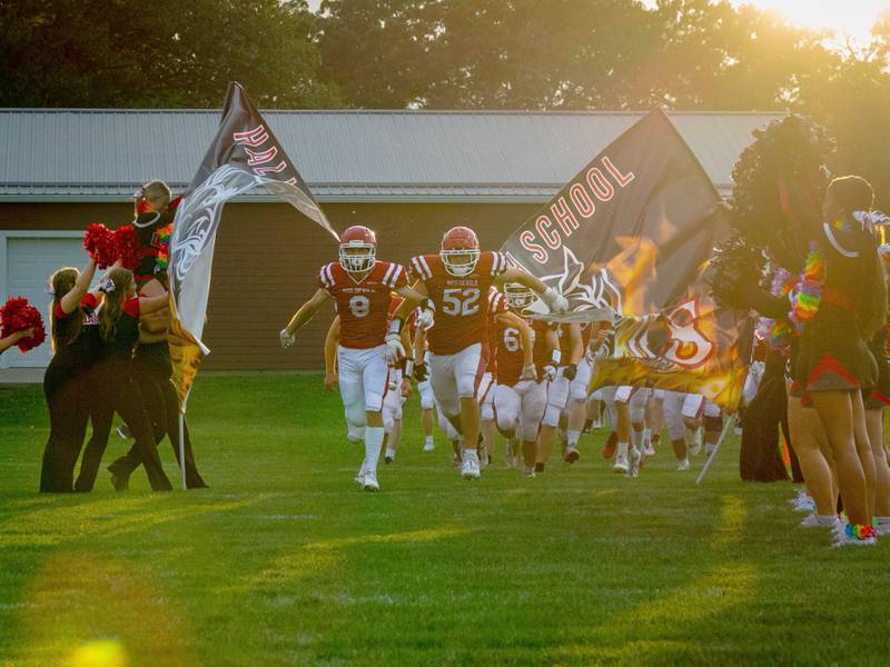 Hall’s Varsity Football team breaks through banner in celebration of the first home game of the season on Friday, August 30, 2024 at Richard Nesti Stadium in Spring Valley.