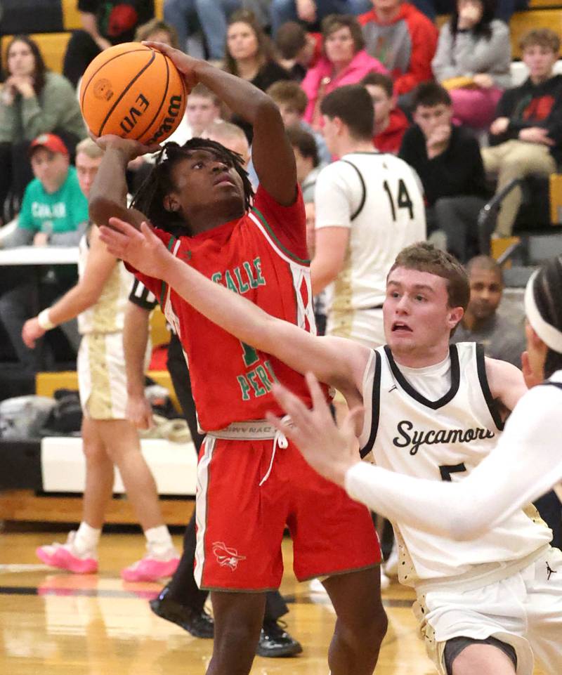 La Salle-Peru's Cordell Wheatley shoots over Sycamore's Preston Picolotti during their game Tuesday, Feb. 4, 2025, at Sycamore High School.