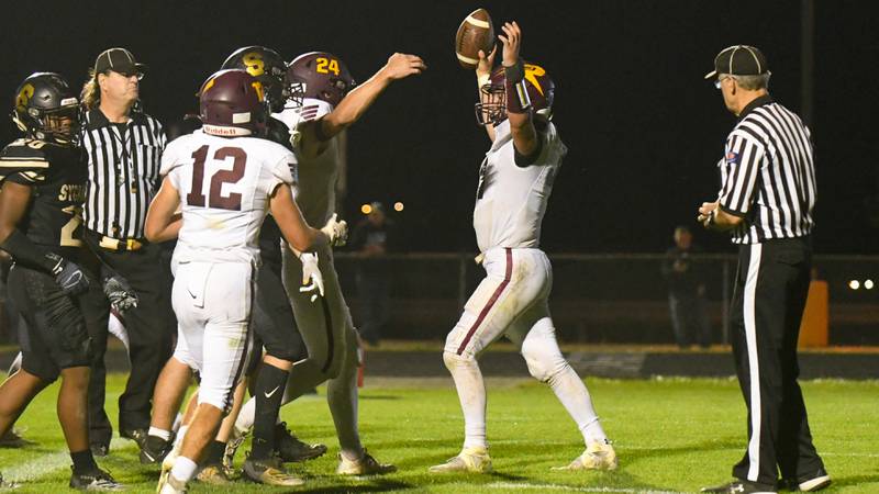 Richmond-Burton Brock Wood (34), center, celebrates with teammates after scoring a touchdown in the fourth quarter Oct. 1st while traveling to play Sycamore.