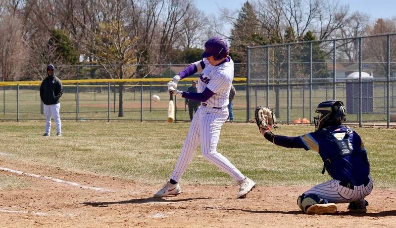 Rochelle's Andrew Huerta follows through on a hit during the Hubs' game with Ottawa Marquette.