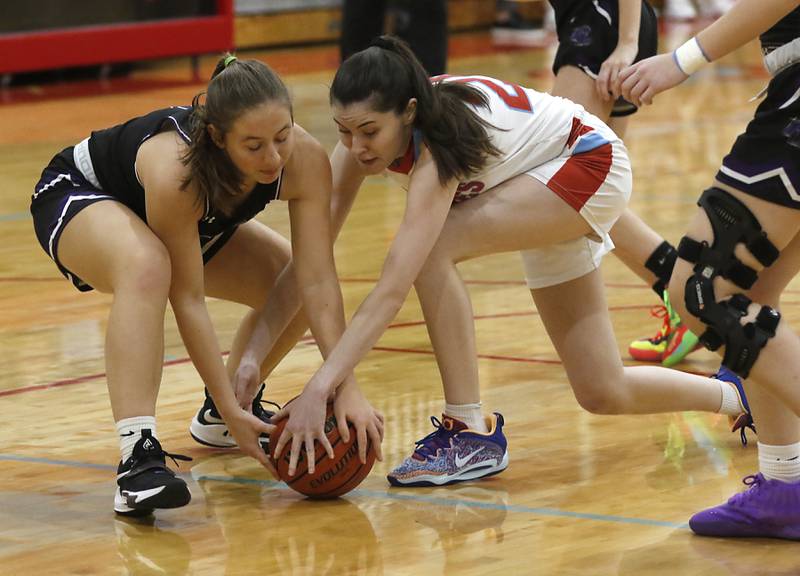 Rockford Lutheran's Addie Richard and Marian Central's Kiara Kelly battle for a loose ball during a non-conference girls basketball game Monday, Dec. 12, 2022, between Marian Central and Rockford Lutheran at Marian Central Catholic High School, in Woodstock.