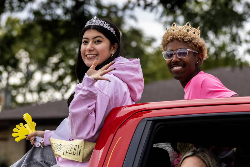 Senior Homecoming Queen Khloe Corez and Senior Homecoming King Kameron Moreno wave to spectators along Glenwood Ave. in Joliet during the Joliet West homecoming parade on Oct. 10, 2025.