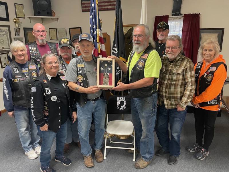 The American Legion Riders of Sandwich Post #181 are shown with a collection of World War II dogtags. Pictured from left are Sandy Lawrence, Sam Mataya, Sally Kolb, Cliff Oleson, Rich Arnett, Bill Kolb, Bob Lawrence, Bob Mauer, Henry Herbst and Cherie Mauer.