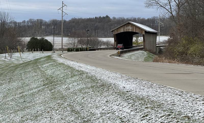 A motorist travles over the Captain Swift Bridge as a light dusting of snow covers the ground on Thursday, Nov. 21, 2024 in Princeton.