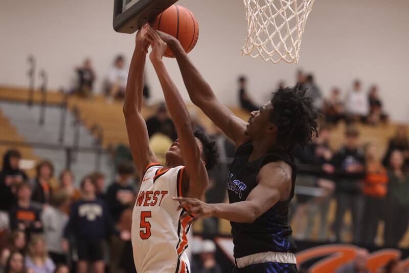 Lincoln-Way East’s Tylon Toliver blocks a shot against Lincoln-Way West.