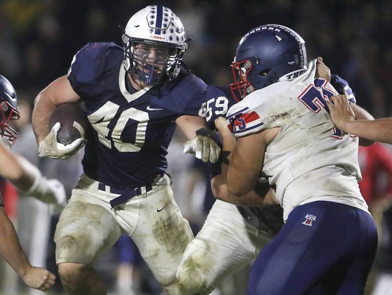 Cary-Grove's Logan Abrams fights for running room during an IHSA Class 5A quarterfinal playoff football game against Belvidere North on Friday, November 14, 2025, at Cary-Grove High School, in Cary.
