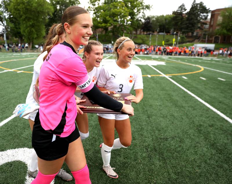Wheaton Warrenville South players Marilyn Dixon, Ashlyn Adams and Brooke Ittersagen celebrate their Class 3A Glenbard West Sectional final win against St. Charles North on Friday, May 30, 2025 in Glen Ellyn.