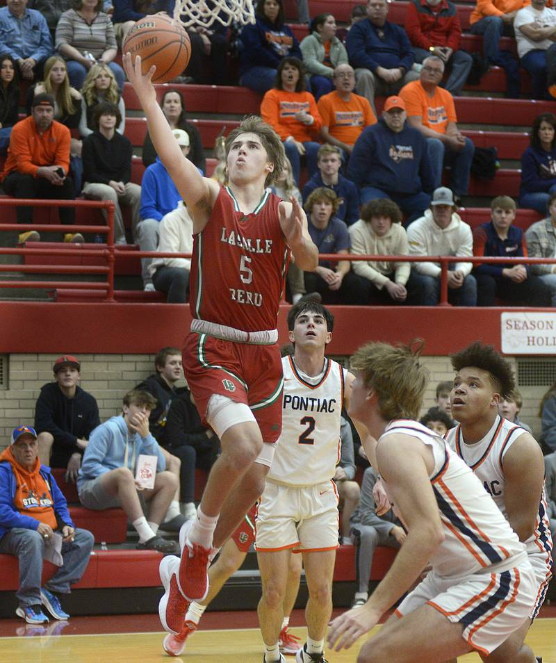 La Salle Peru’s Seth Adams goes in for a layup against Plano in the 1st period Saturday during the Dean Riley Shootin’ The Rock Thanksgiving Tournament at Ottawa.