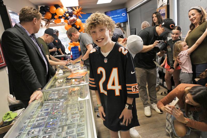 Jonah Davis, a 14-year-old heart patient from Downers Grove greets at a surprise party at Mark’s Card Shop in Downers Grove on Tuesday, Oct. 29, 2024.