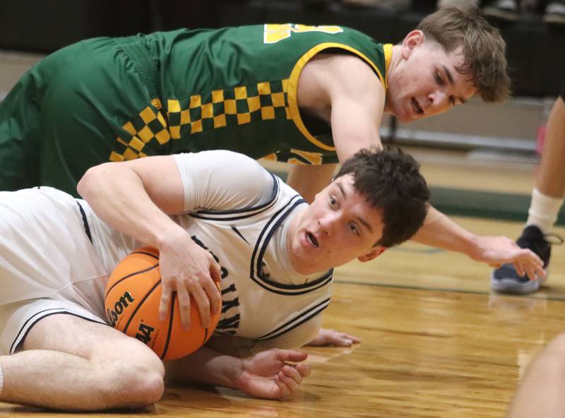 Crystal Lake South’s Nick Stowasser, top, tussles with Cary-Grove’s Brady Bauer for the ball in boys IHSA Class 3A Regional Championship basketball on Friday, Feb. 27, 2026, at Crystal Lake South High School in Crystal Lake.