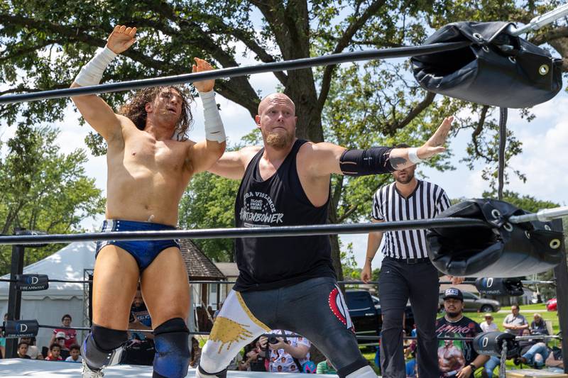 (left to right) Channing Thomas gets irish whipped into corner by Hartenbower at the Taste of the Illinois Valley DreamWave Wrestling event on Saturday, August 2, 2025 at Centennial Park in Peru.