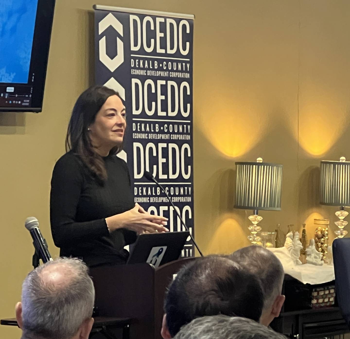 Meta worker Tara Tenorio spoke to a crowd of business leaders at an annual DeKalb County Economic Development Corporation event in DeKalb on Dec. 2, 2025.