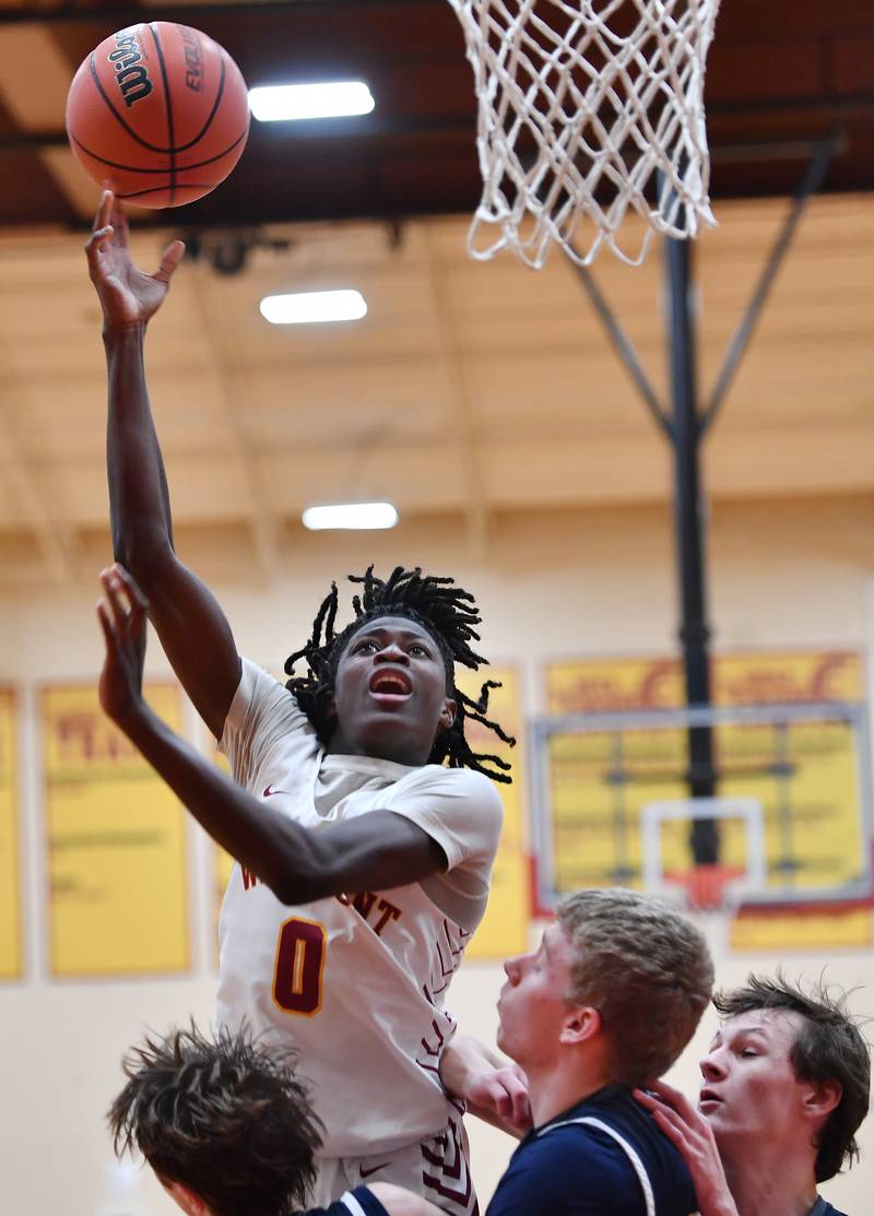 Westmont's Abraham Johnson (0) lays the ball up during a game against IC Catholic Prep on Jan. 5, 2024 at Westmont High School in Westmont.