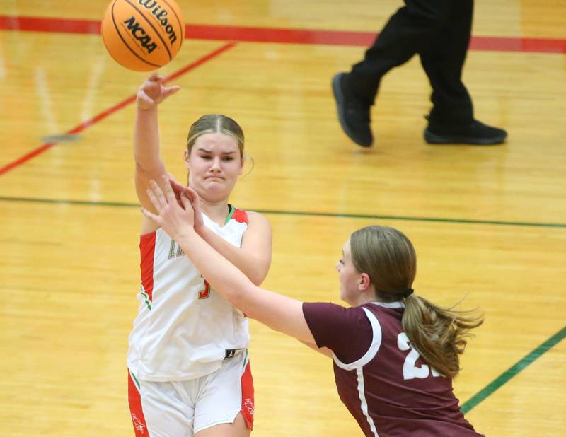 L-P's Emma Jereb passes the ball off as Morris's Layken Callahan on Friday, Dec. 6, 2024 in Sellett Gymnasium at L-P High School.
