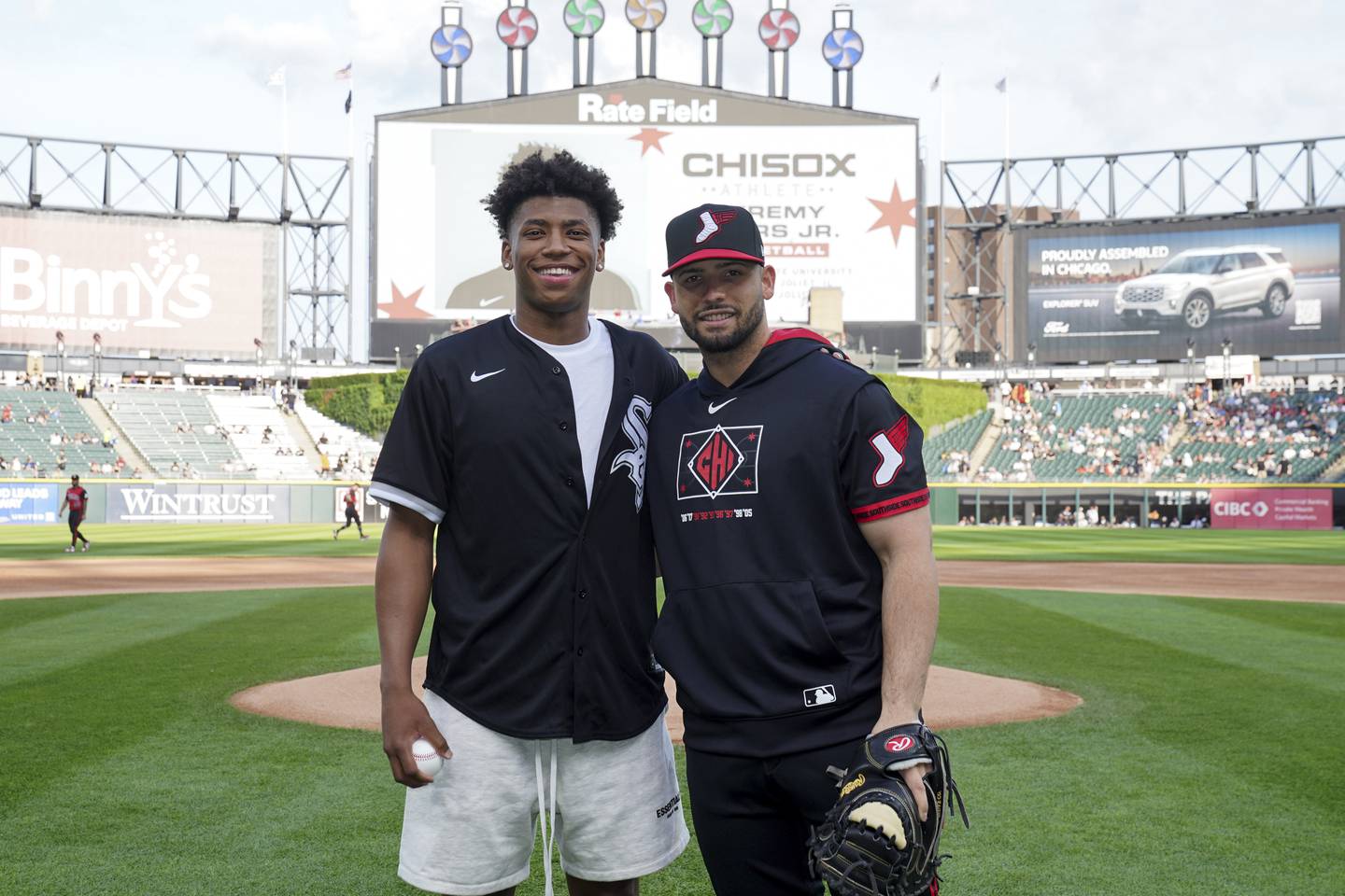 Jeremy Fears Jr. alongside a White Sox staff member.