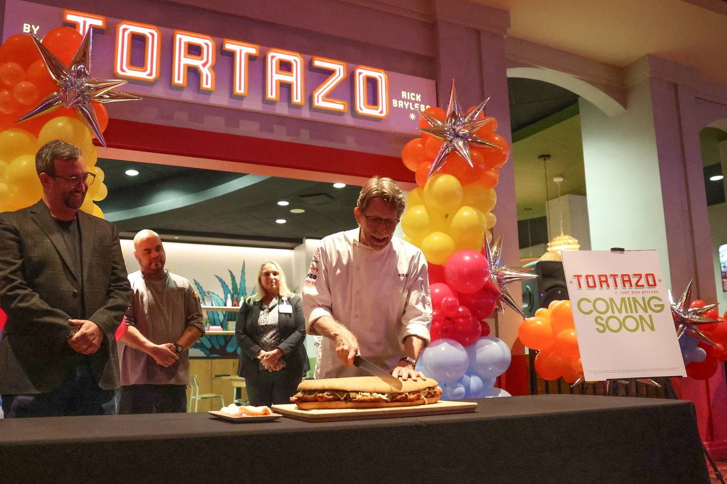In lieu of a ribbon cutting, chef Rick Bayless cuts a tortas for the opening of Tortazo restaurant inside Harrah’s Casino Joliet on Friday, Oct. 4, 20234 in Joliet.