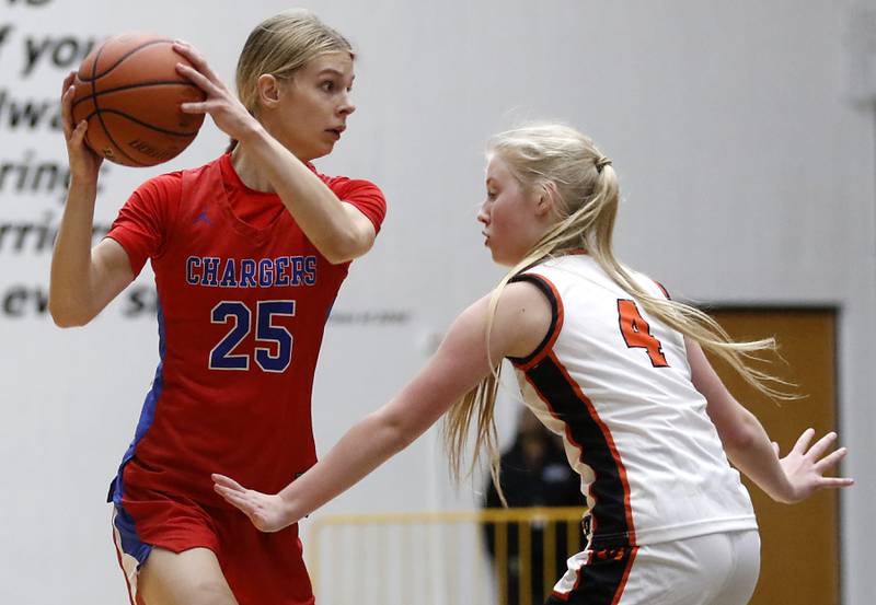 Dundee-Crown’s Monica Sierzputowski looks to drive on McHenry's Holly Waters during a Fox Valley Conference girls basketball game on Tuesday, Dec. 12, 2023, at McHenry High School.