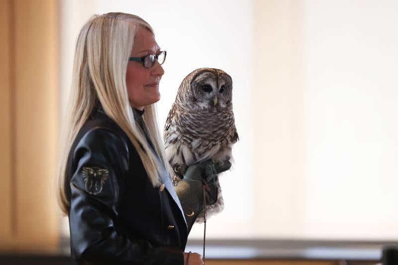 Dianne Moller, Director of Hoo’s Woods Raptor Center, gives a presentation while holding Clark, a rescued Barred Owl, at the Four Rivers Environmental Education Center’s annual Eagle Watch program in Channahon.