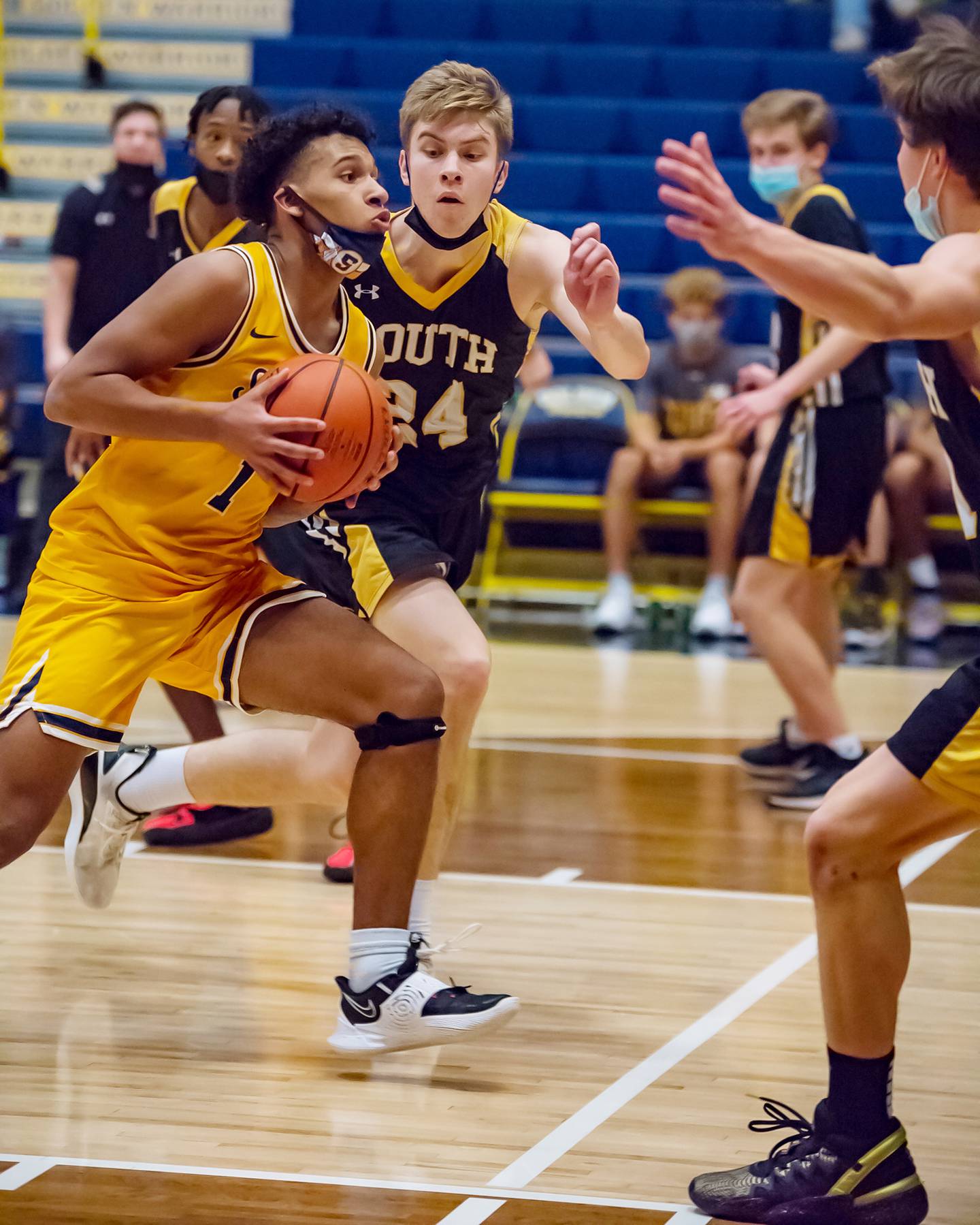Sterling's Tyree Kelly (left) drives to the basket against Hinsdale South's Garrett Bolte during their Sterling MLK tournament game Saturday evening at Musgrove Fieldhouse.