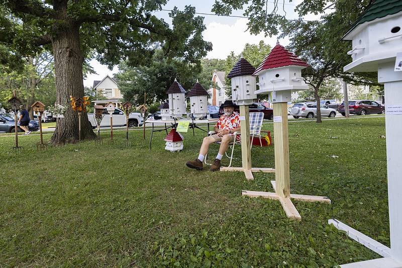 Michael Scarantino sits with his display of birdhouses Saturday, July 6, 2024 during the Nuts About Art exhibit at John Dixon Park. Scarantino makes the houses by hand and can custom make to fit the customer's wants.
