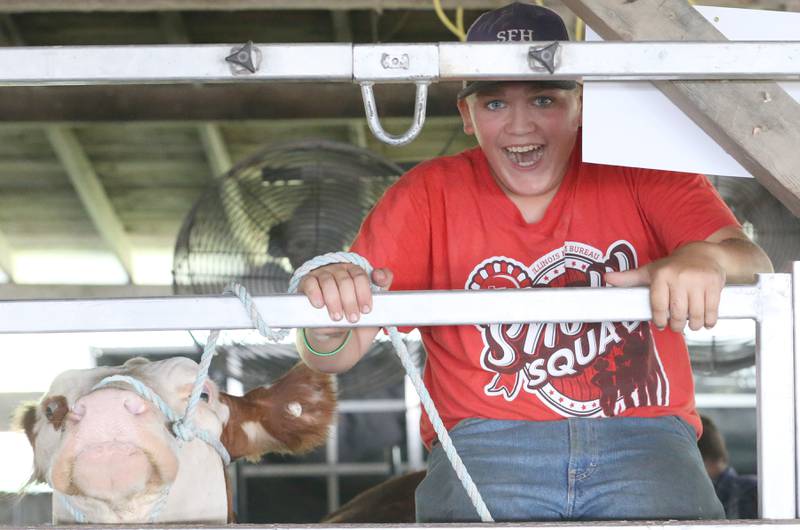 Karson Sundbert of Mendota, rides on top of one of his steers before showing it in the La Salle County 4-H Fair on Friday, July 14, 2023 in Ottawa.