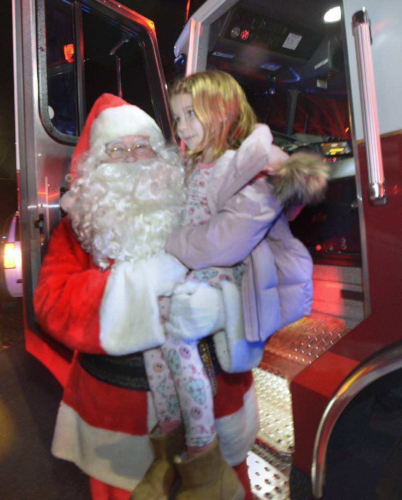 Santa gives Quinn an up close visit to the Spring Valley Fire Truck.