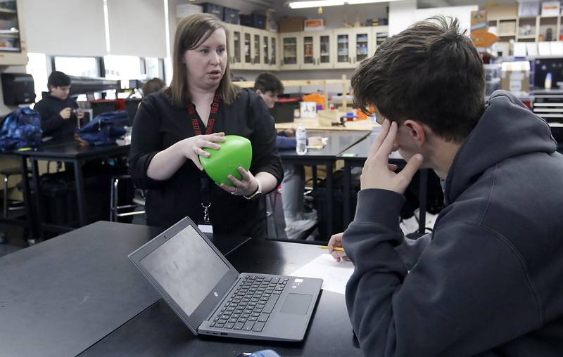 Teacher Amanda Henk talks with Jack Breunig as she teaches a robotics class Tuesday, May 2, 2023, at Huntley High School in Huntley.