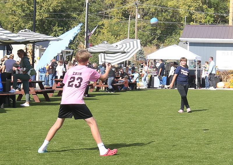 Dax Manicki of Utica and Webb Hanson of La Salle, play catch on the green space of Market on Mill during the 55th annual Burgoo Festival on Sunday, Oct. 12, 2025 in Utica.