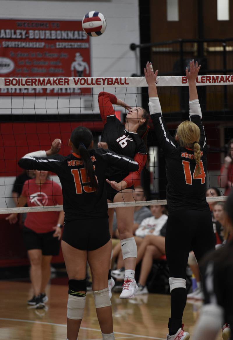 Bradley-Bourbonnais' Olivia Woolman, center, delivers a hit over the net as Beecher's Anahi Lagunas, left, and Sydney Kettmann, right, defend in a match on Tuesday, September 2, 2025.