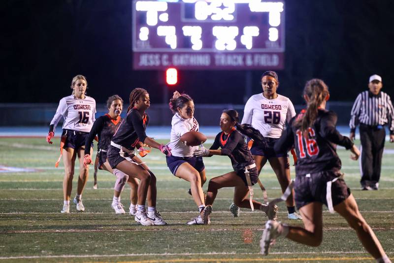 Oswego's Violette Wisniowicz reaches for a first down near the end of the fourth quarter as Yorkville defenders close in during Yorkville's 2-1 overtime victory over Oswego in the IHSA Kankakee Regional championship game on Thursday, Oct. 9, 2025.