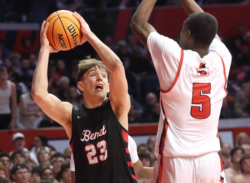 Benet’s Edvardas Stasys looks to score over Marist's Stephen Brown Saturday, March 14, 2026, during their IHSA Class 4A state championship game in the State Farm Center at the University of Illinois in Champaign.
