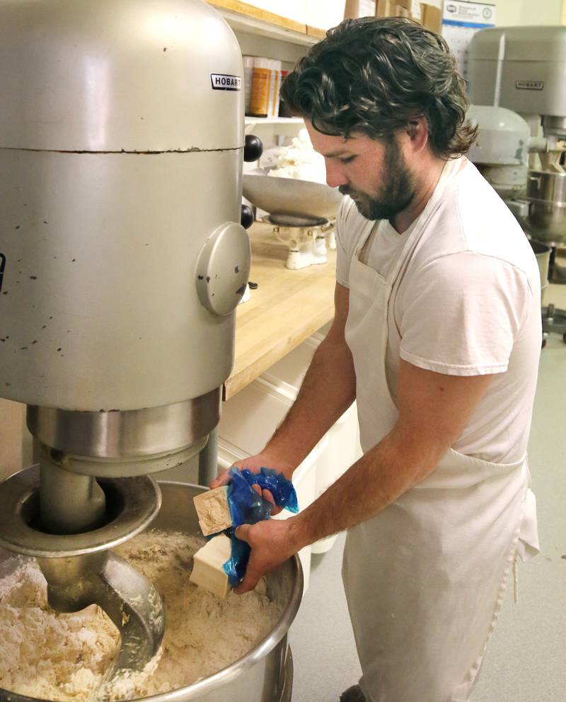Eric Elleson, son of Ken Elleson, owner of Elleson's Bakery, mixes the dough before it is sliced up for paczkis Monday, Feb. 28, 2022, in the kitchen of the bakery in Sycamore. Eric Elleson came in from Michigan especially for this day to help out his dad and members of his family who will be working all night making the paczkis from scratch to be ready at 5 a.m. tomorrow for Fat Tuesday.