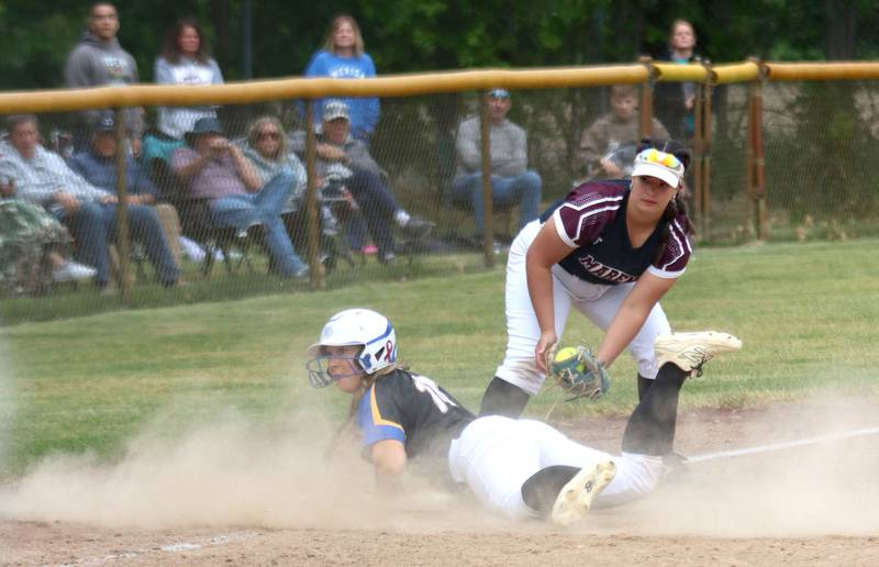Marengo’s Mia Miceli fields a throw as Aurora Central Catholic’s Morgan Vaghy slides safely at third base in varsity girls softball IHSA Class 2A Regional Title Game action on Friday, May 22, 2026 at Raymond Benoy Field on the campus of Marian Central High School in Woodstock.