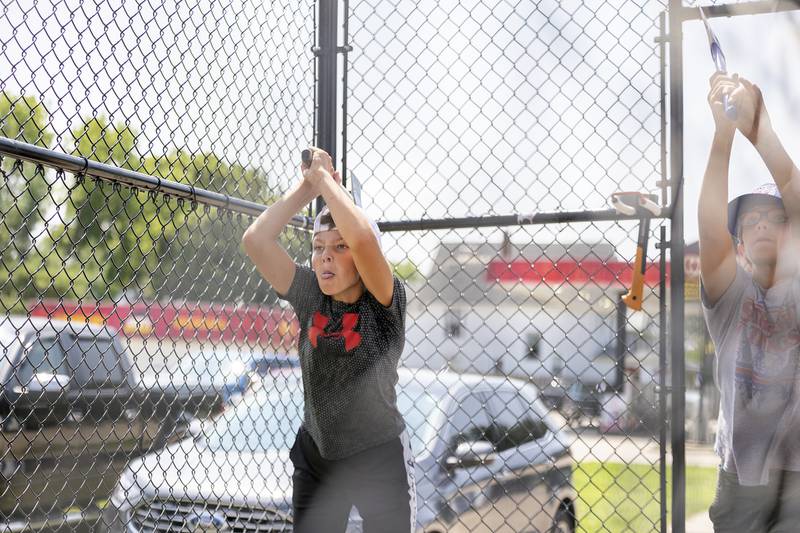 Kyhlor Thomas (left), 10, and CJ Lawson, 11, both of Tampico unleash their throws at the Whoop Your Axe booth Saturday, July 22, 2023 at Tampico Days.