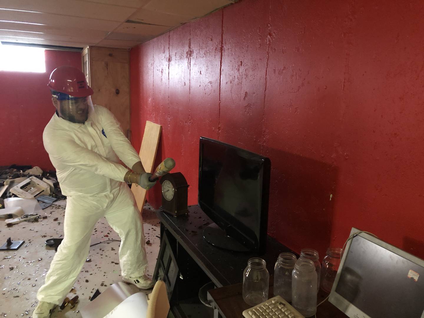 Ricky Evans, of McHenry, winds up to take a swing at a flat screen TV at the House of Rage on Dec. 28, 2022. The rage room opened at 4805 West Elm Street in November.