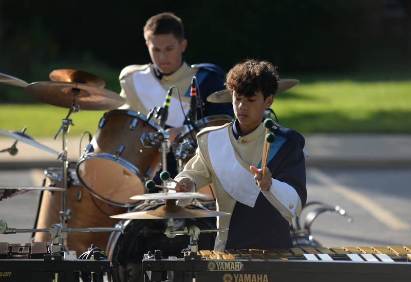 Lemont High School Marching Band members including (back) Nicholas Splitt and Emmett Farrell practice prior to participating in the annual Music Bowl Competition held at Downers Grove South Saturday, Oct. 7, 2023.