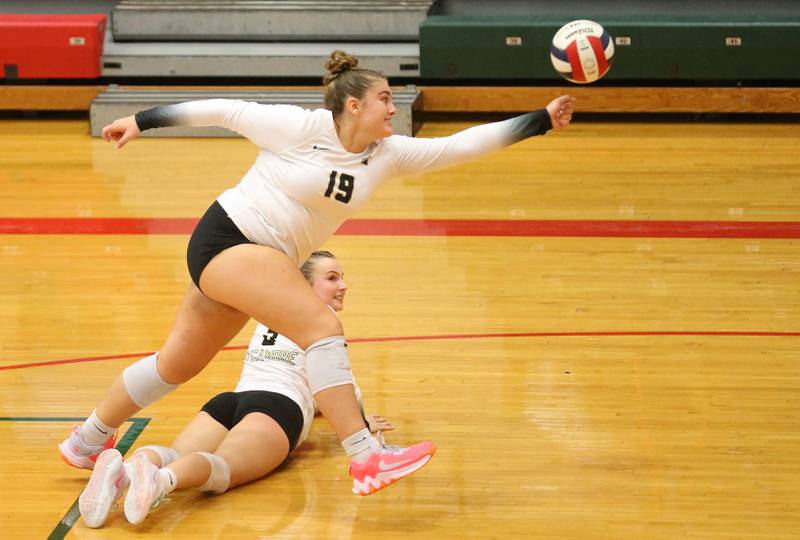 Sycamore's Sophia Martinez hurdles her teammate Elizabeth Goff to try to save the ball from going out of play against L-P on Tuesday, Sept. 23, 2025 in Sellett Gymnasium at L-P High School.