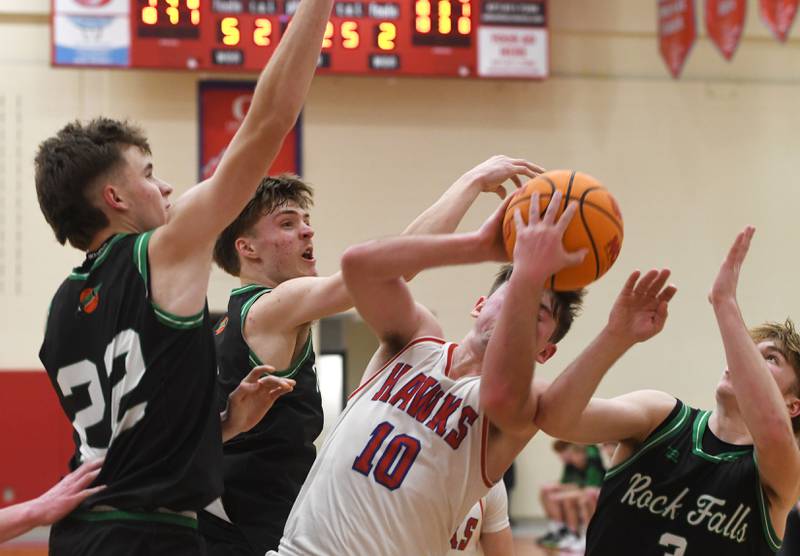 Oregon's Keaton Salsbury (10) battles Rock Falls' Owen Laws, Max Burns, and Cole Heald on Friday, Jan. 9, 2026 at the Blackhawk Center in Oregon.