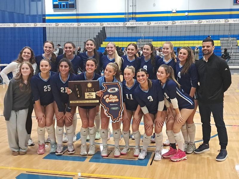The Nazareth volleyball team poses with the supersectional plaque after beating Fenwick in the Class 3A De La Salle Supersectional.