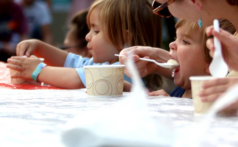 Everett Kalisz, left, 3, of Algonquin, and John Rueff, right, 2, of Crystal Lake, take part in an ice cream-eating contest Friday, Aug. 18, 2023, as part of Julie Ann’s first-ever Ice Cream Fest at Crystal Lake’s Main Beach.