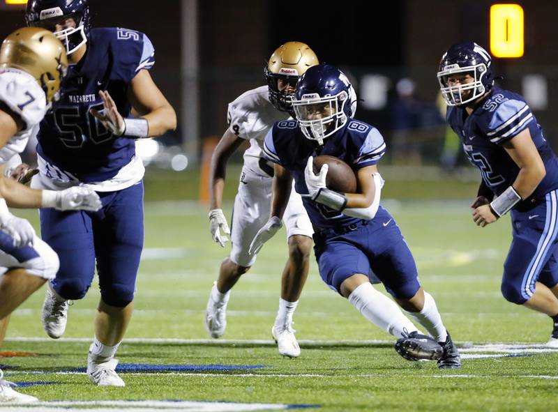 Nazareth Academy's Ethan Enriquez (8) runs the ball during the boys varsity football game between Lemont High School and Nazareth Academy on Friday, Sept. 2, 2022 in LaGrange, IL.