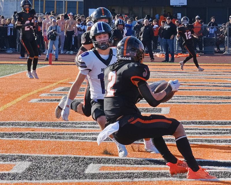 Lincoln-Way West's Braden Erwin (2) intercepts a pass in the end zone intended for Downers Grove North's Oliver Thulin to stop the Trojans' opening drive during an IHSA Class 7A quarterfinal game on Nov. 11, 2023 at Lincoln-Way West High School in New Lenox.