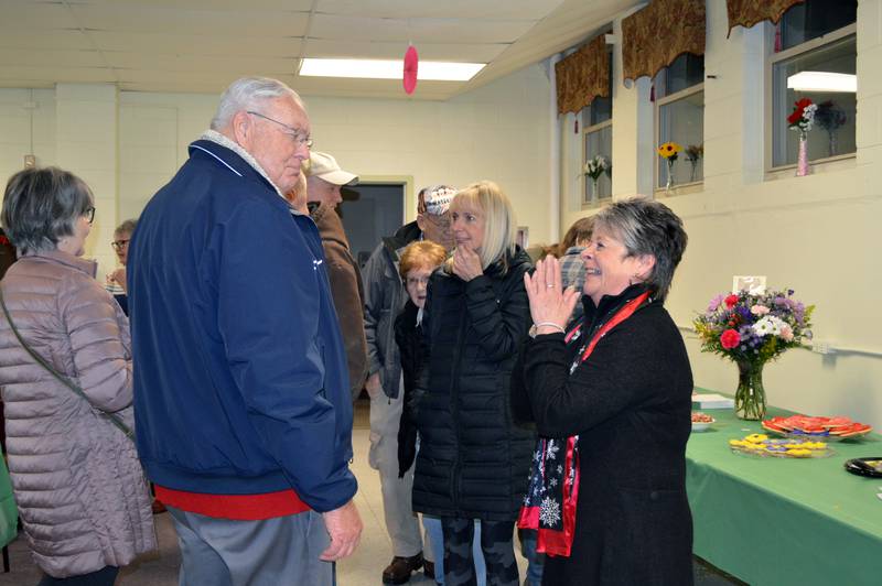 Paula Diehl, right, smiles as she talks to John Finfrock during her retirement party on Dec. 30 at the Mt. Morris Senior Center. Diehl, who served as Mt. Morris village clerk for more than 18 years, retired from the position at the end of 2022.