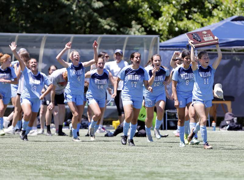 Willows Academy run across the pitch as they celebrate winning the Class 1A Dominican super-sectional between Willows Academy and Richmond-Burton HS in River Forest on Saturday, May 25, 2024.